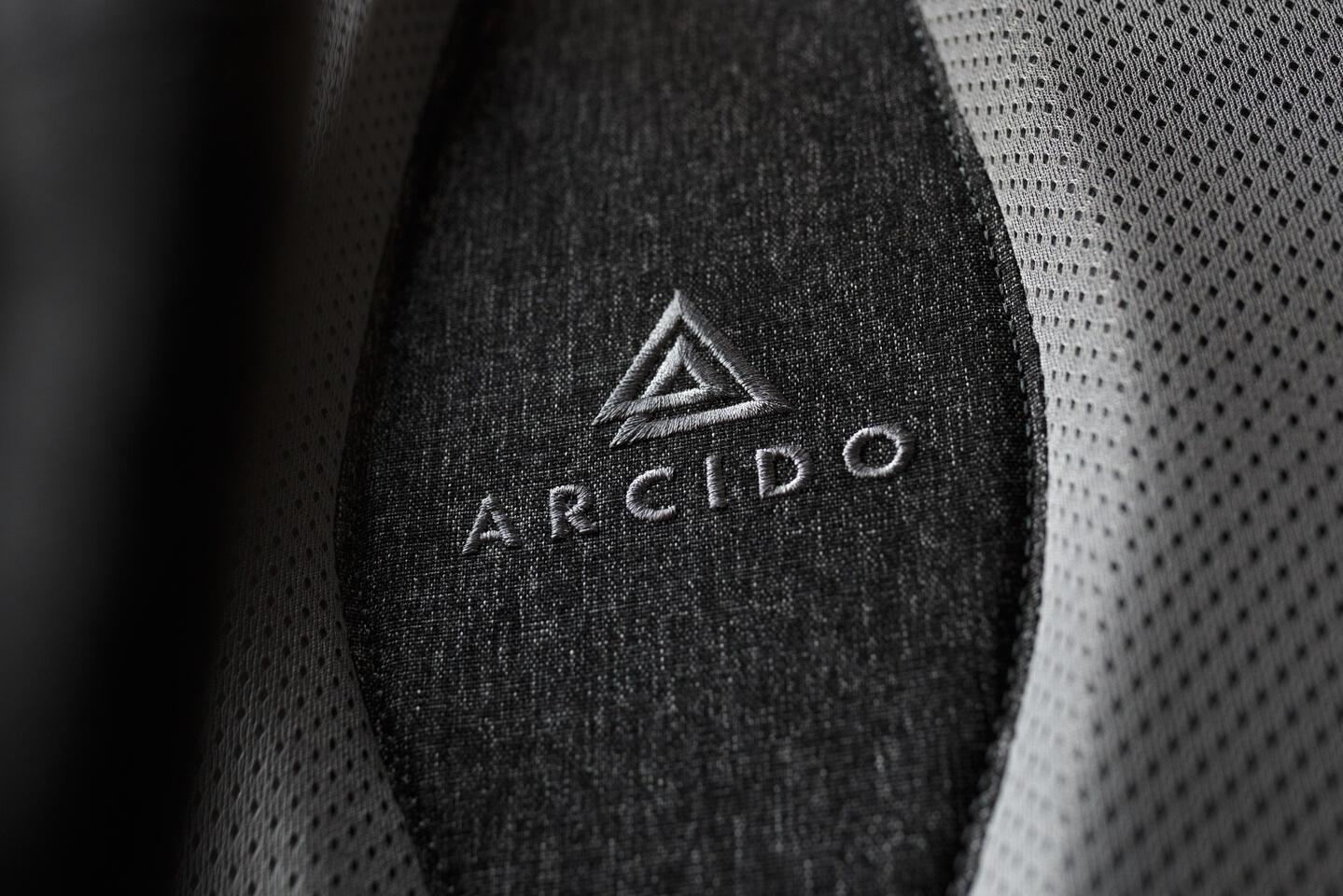 Detail shot of a backside of a travel backpack with logo in the focus