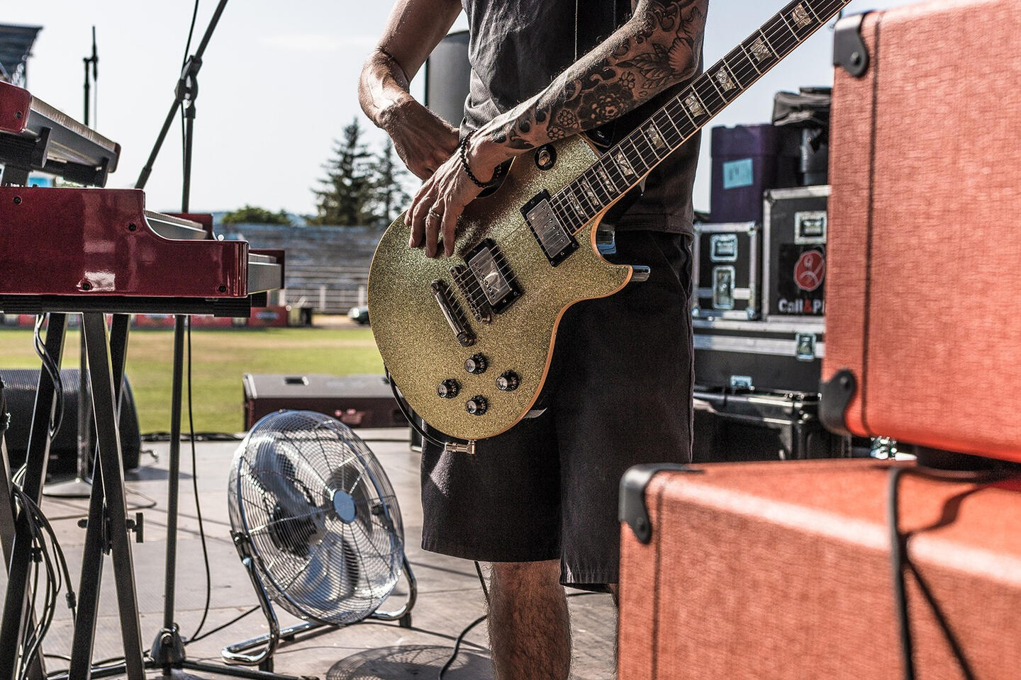 Lifestyle photo of a tour technician holding guitar