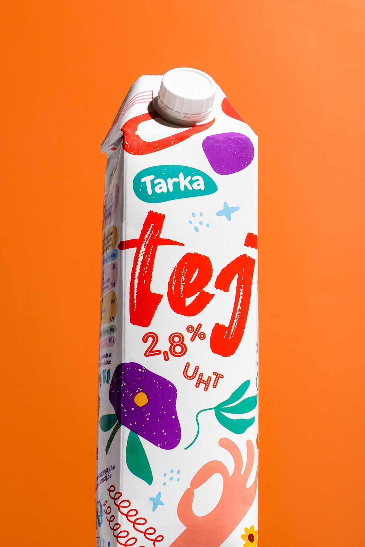 A hero shot of milk packaging on a orange background