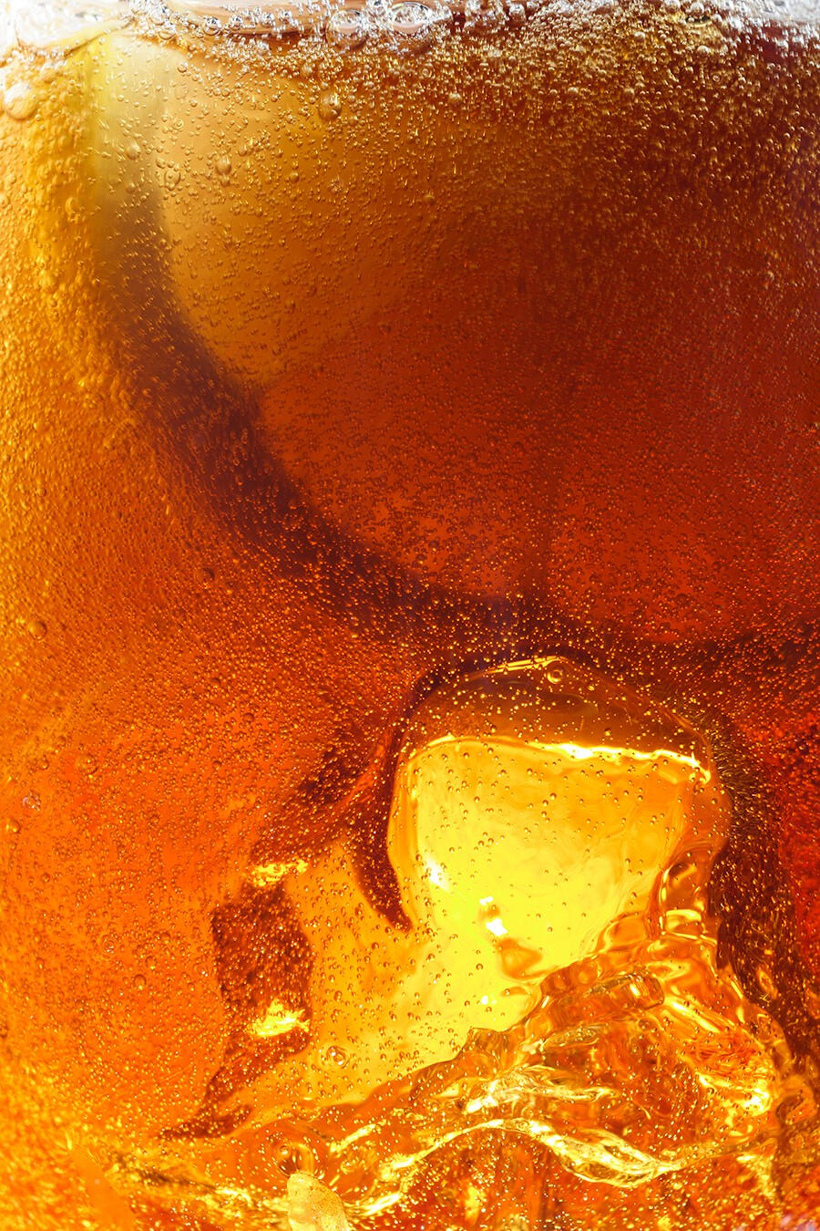 Macro shot of lemon, fizzy drink and ice, summer vibes