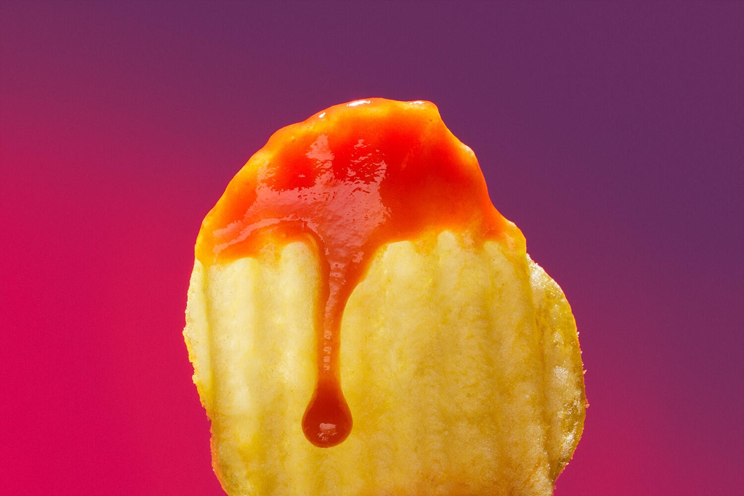 Retro macro shot of crinkled chips with ketchup